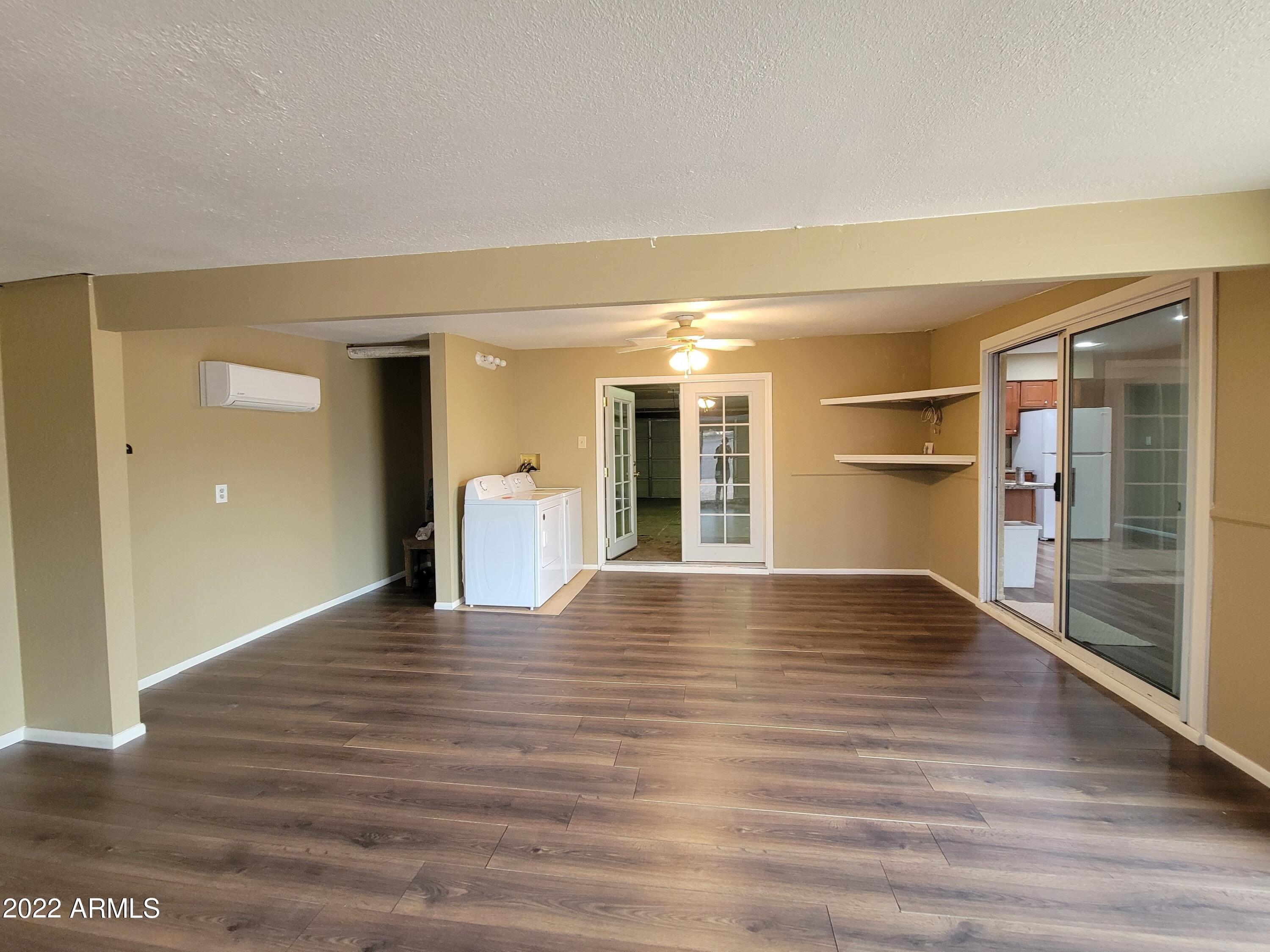 2042 West Decatur Street Mesa, AZ 85201 - Photo 16 of 38 a view of an empty room with wooden floor and a window