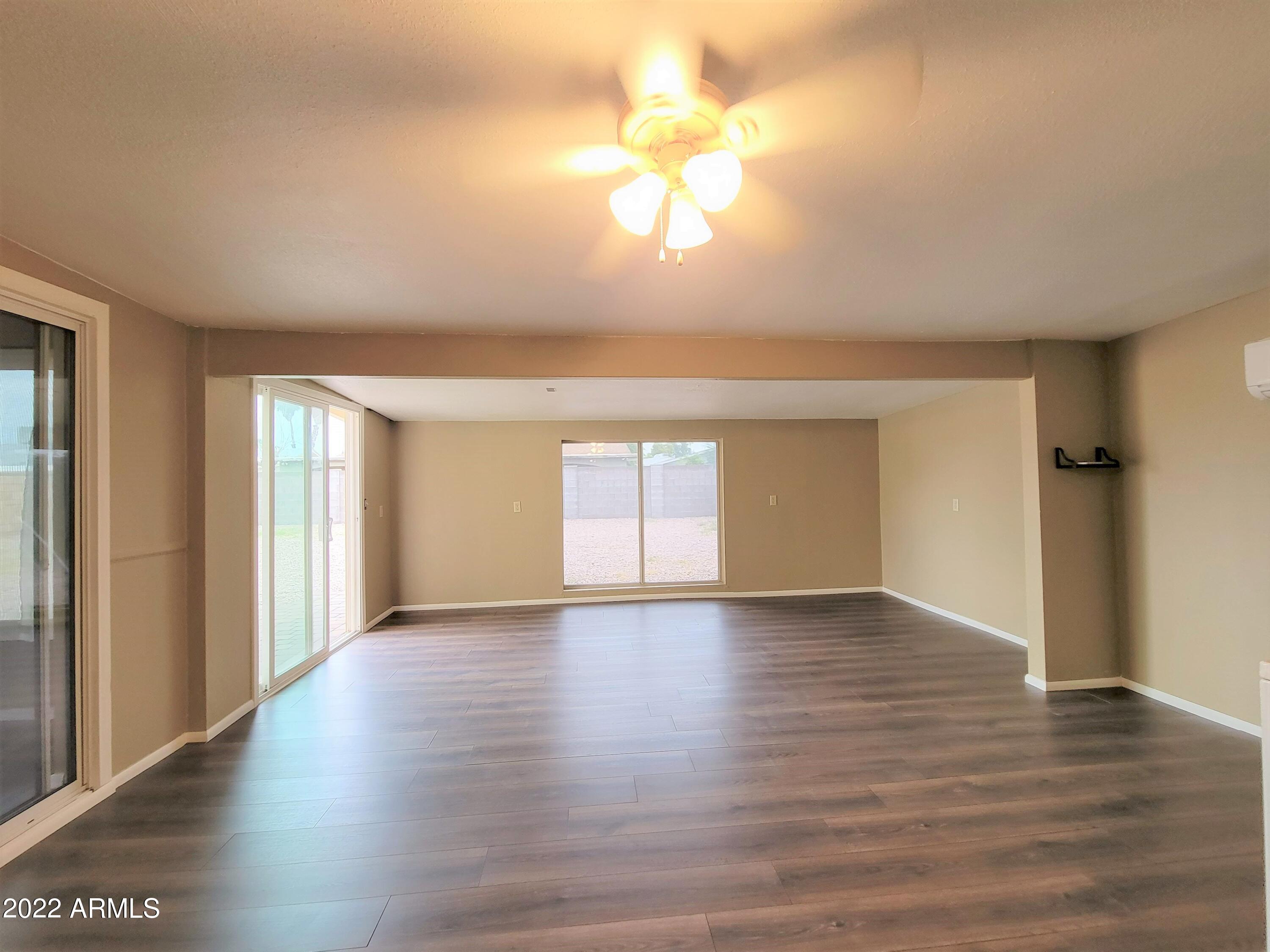 2042 West Decatur Street Mesa, AZ 85201 - Photo 17 of 38 a view of an empty room with wooden floor and a window