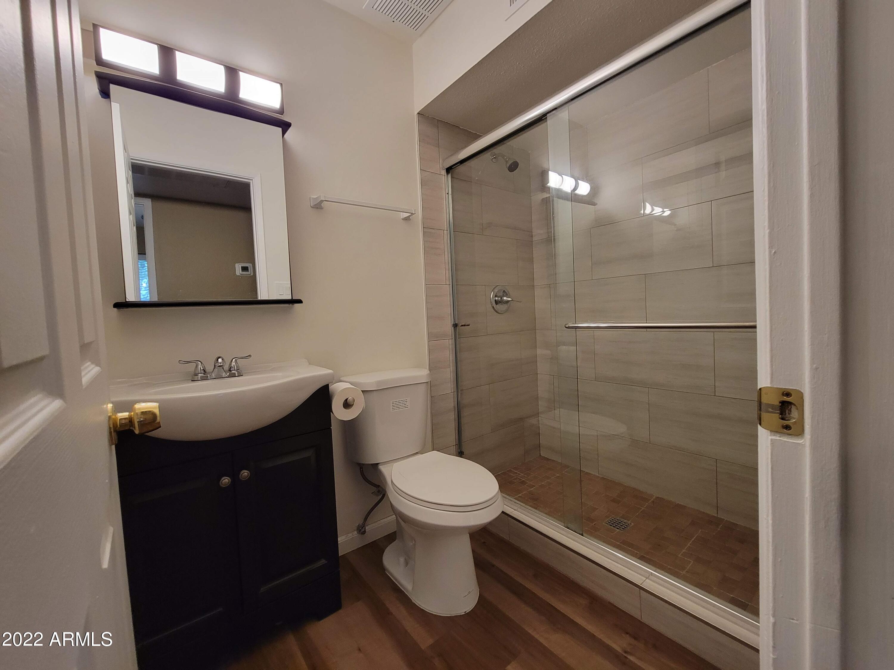 2042 West Decatur Street Mesa, AZ 85201 - Photo 20 of 38 a bathroom with a toilet sink and shower