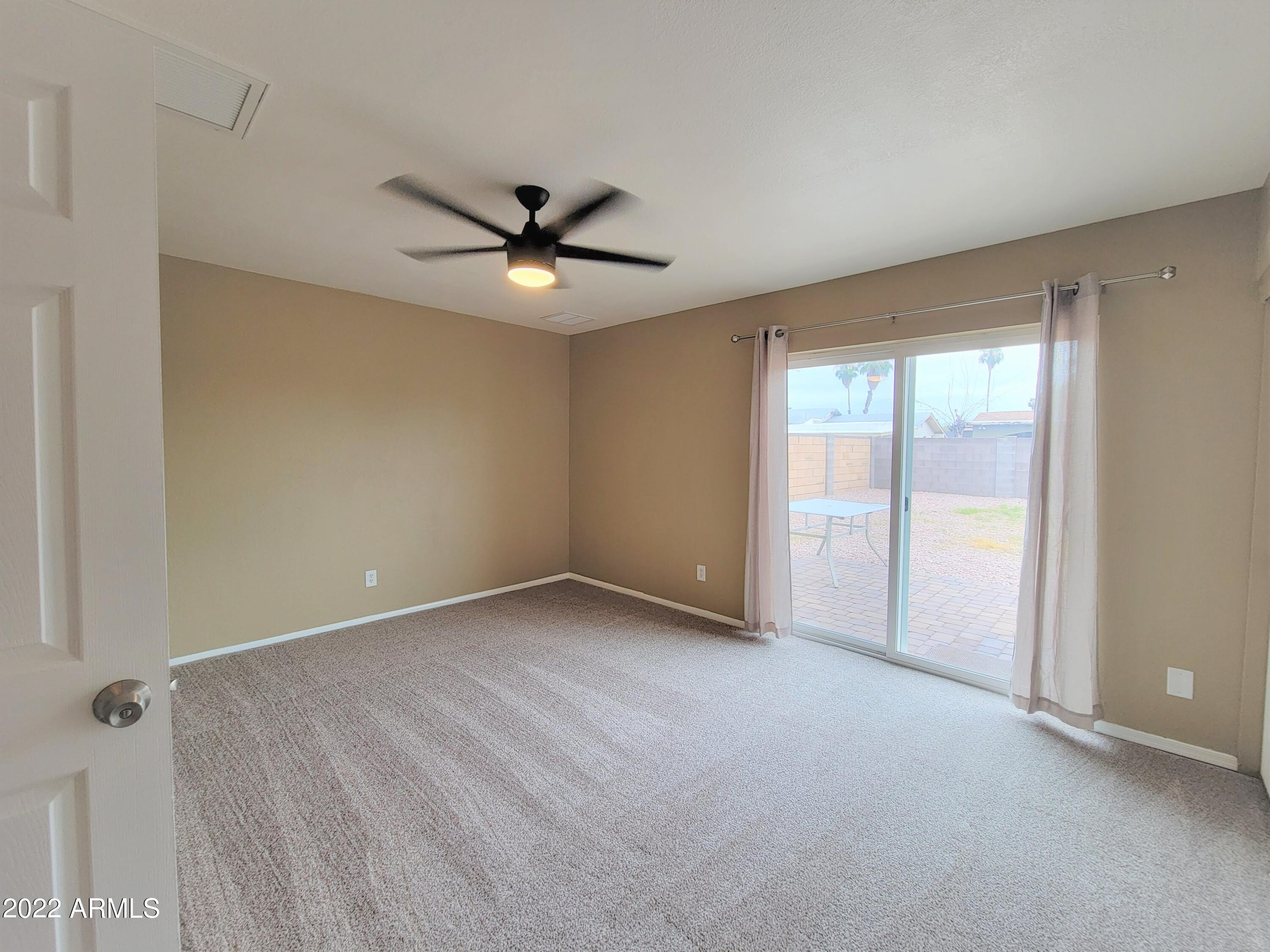2042 West Decatur Street Mesa, AZ 85201 - Photo 21 of 38 a view of an empty room with a window
