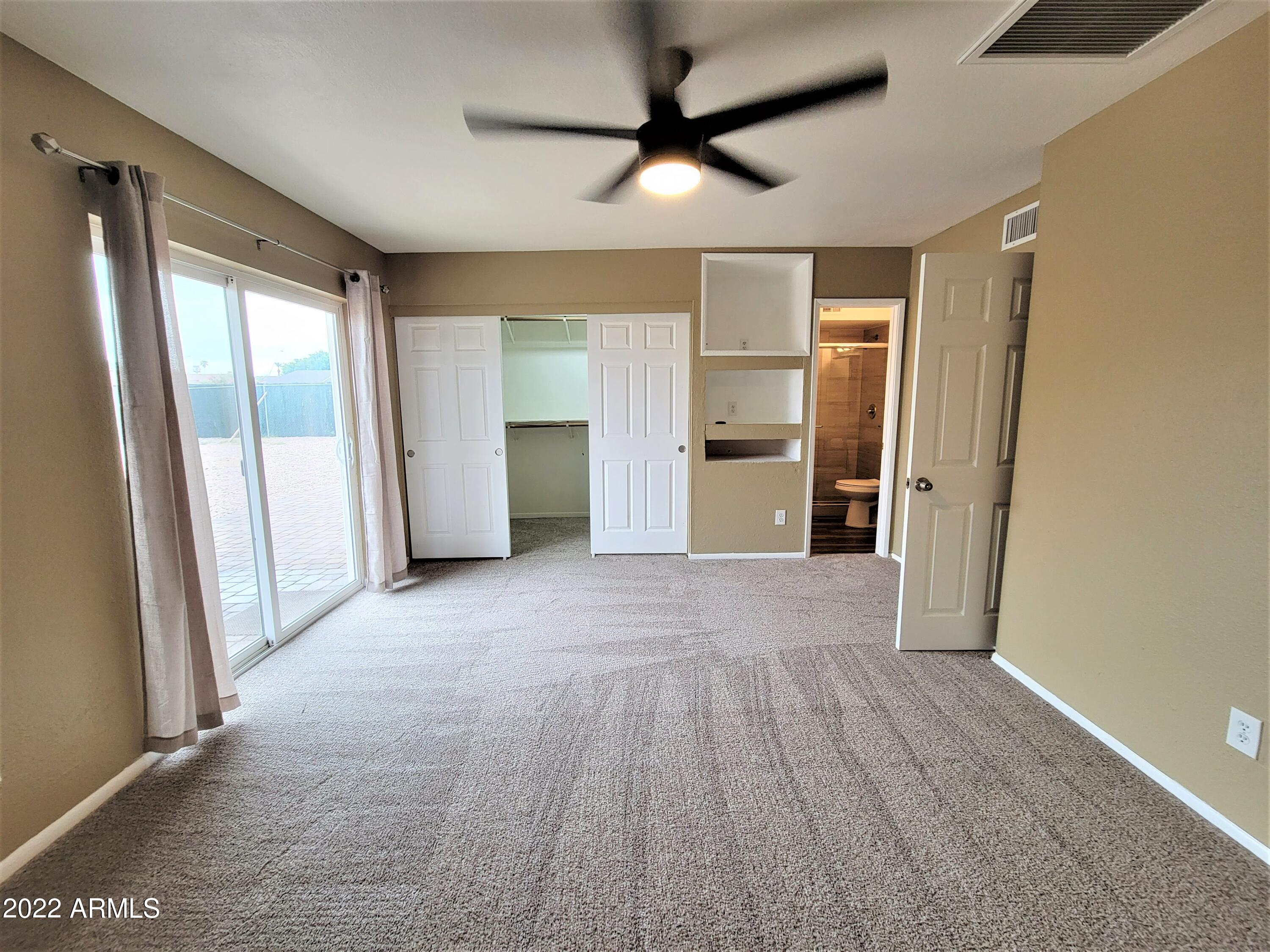 2042 West Decatur Street Mesa, AZ 85201 - Photo 22 of 38 a view of empty room with wooden floor and fan