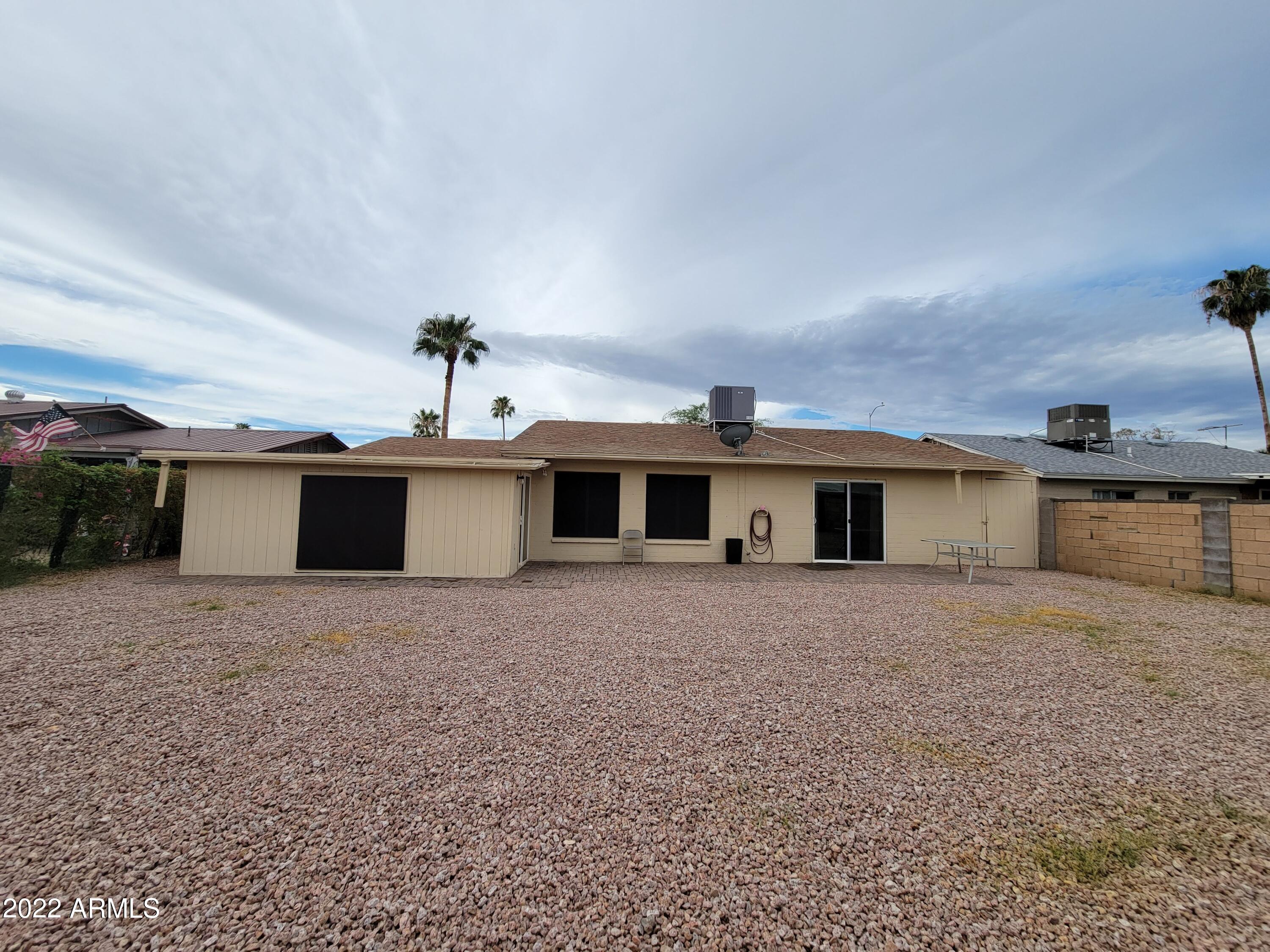 2042 West Decatur Street Mesa, AZ 85201 - Photo 28 of 38 a front view of a house with a yard and garage