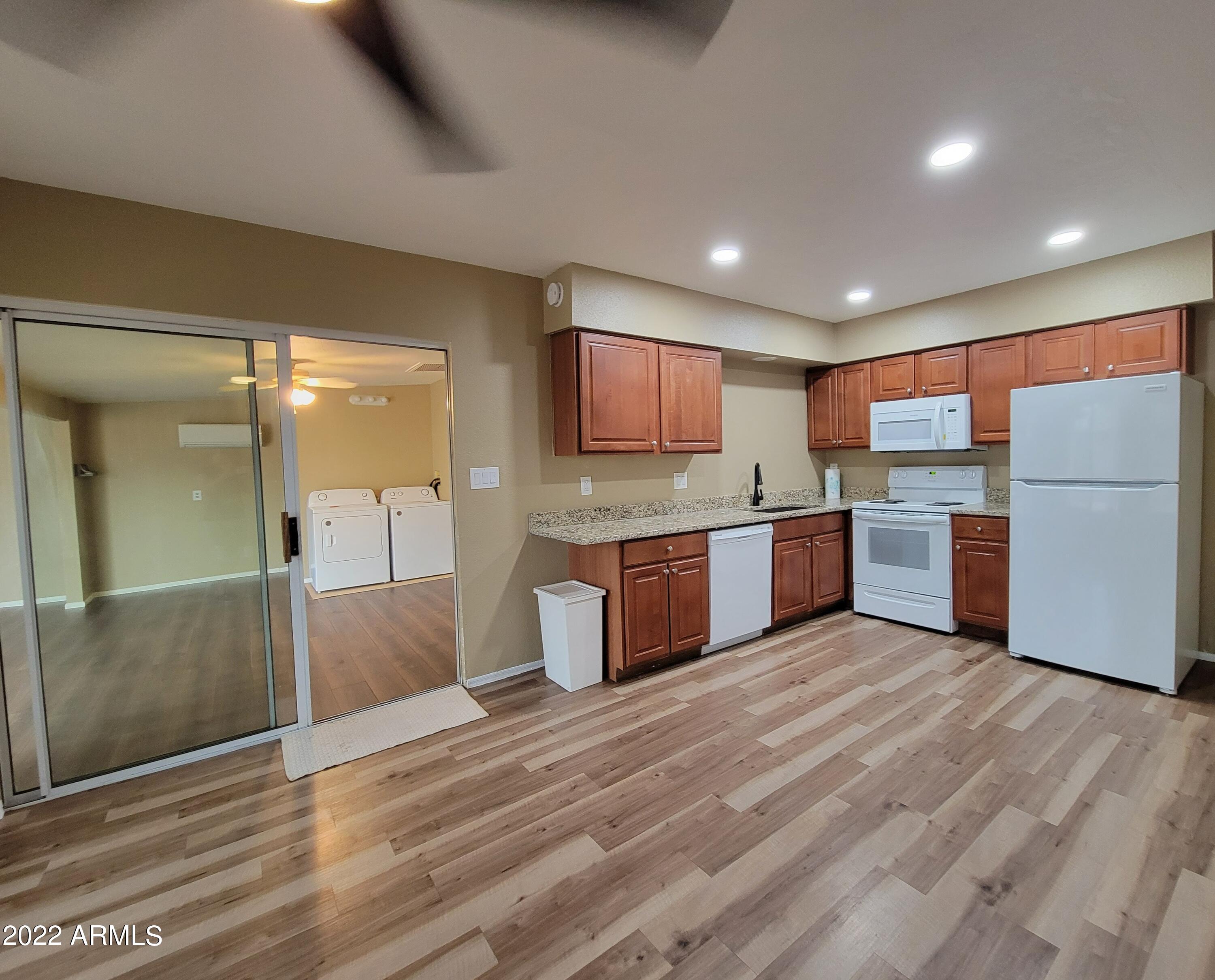 2042 West Decatur Street Mesa, AZ 85201 - Photo 3 of 38 a open kitchen with stainless steel appliances granite countertop a refrigerator and a stove top oven