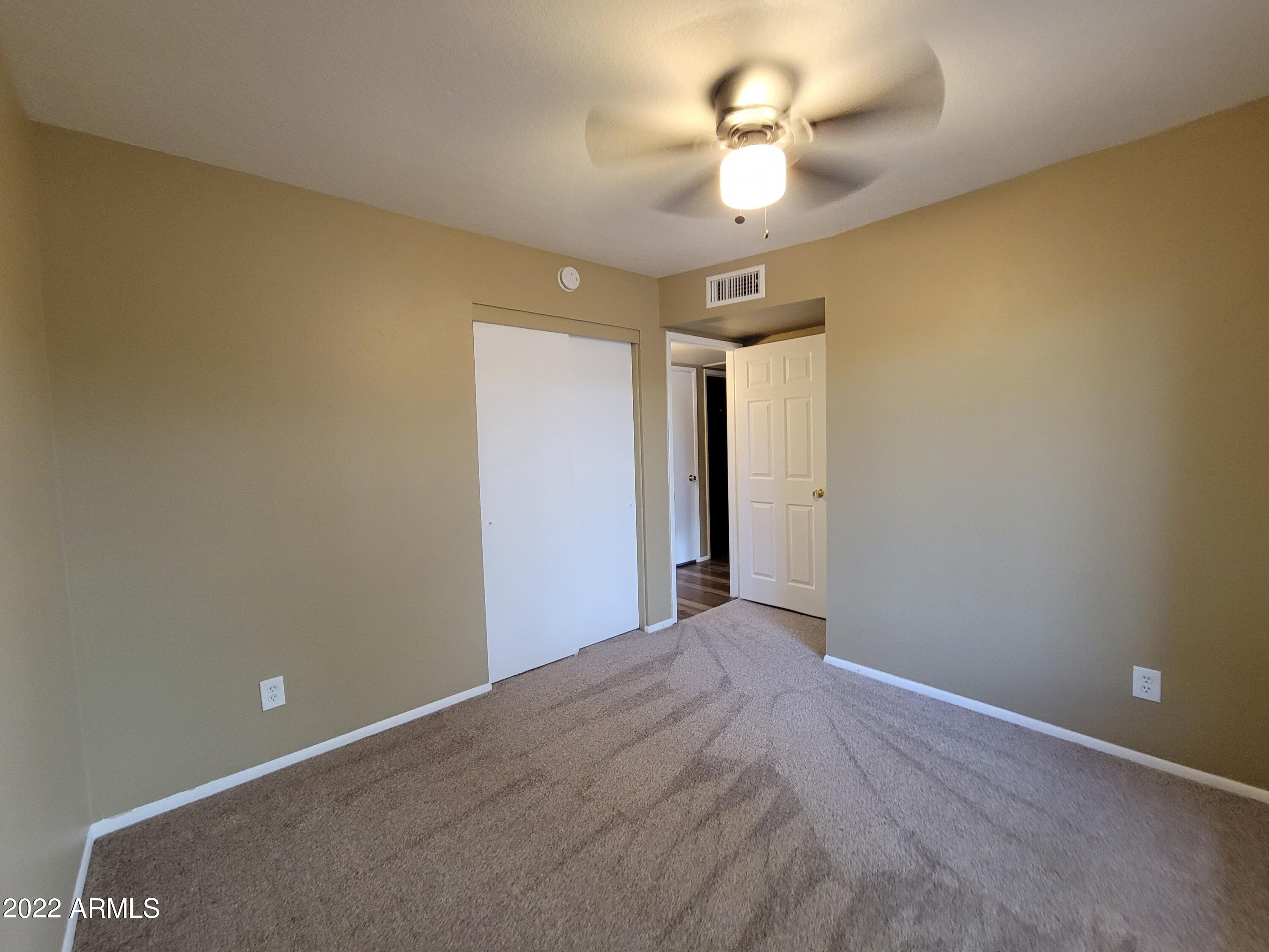 2042 West Decatur Street Mesa, AZ 85201 - Photo 31 of 38 a view of a big room with windows and chandelier fan