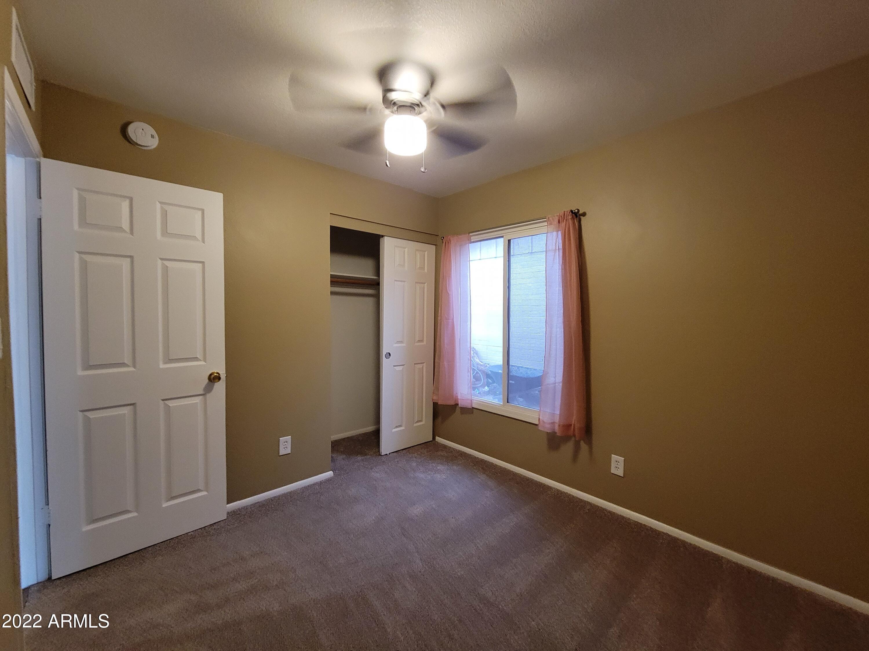 2042 West Decatur Street Mesa, AZ 85201 - Photo 33 of 38 an empty room with windows and fan