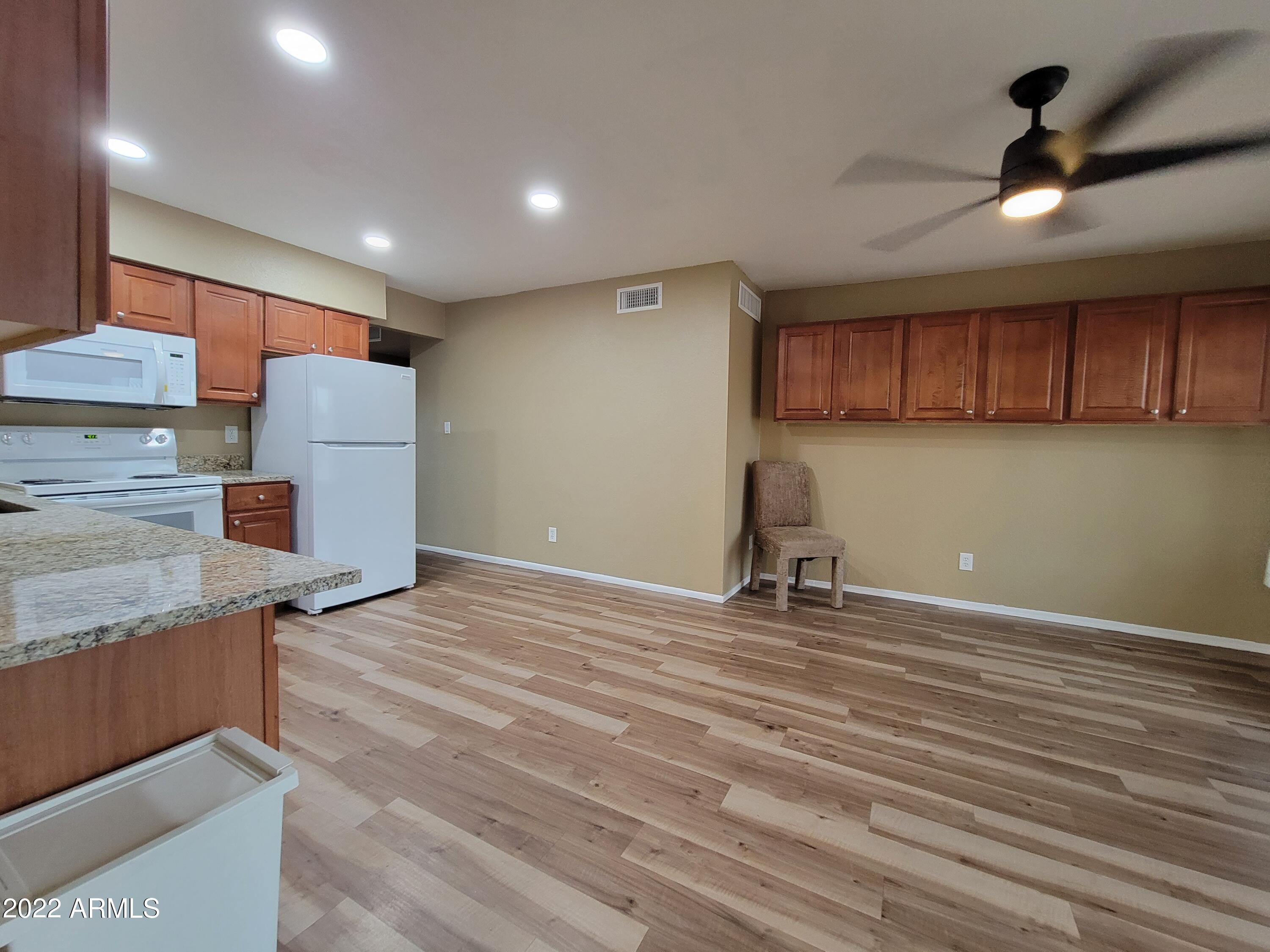 2042 West Decatur Street Mesa, AZ 85201 - Photo 4 of 38 a view of a kitchen with a sink and a refrigerator