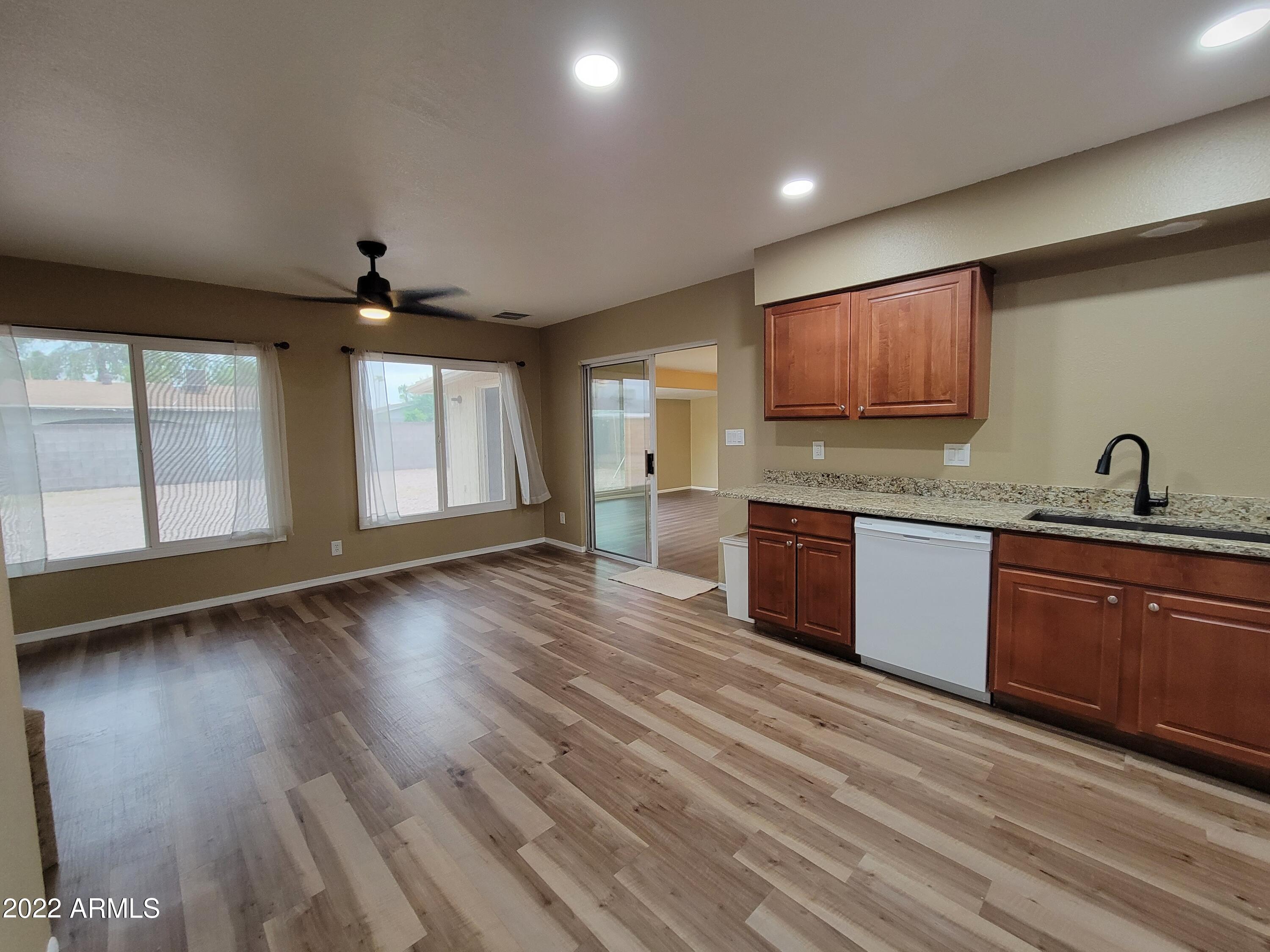 2042 West Decatur Street Mesa, AZ 85201 - Photo 7 of 38 a large kitchen with stainless steel appliances granite countertop a sink and a stove top oven