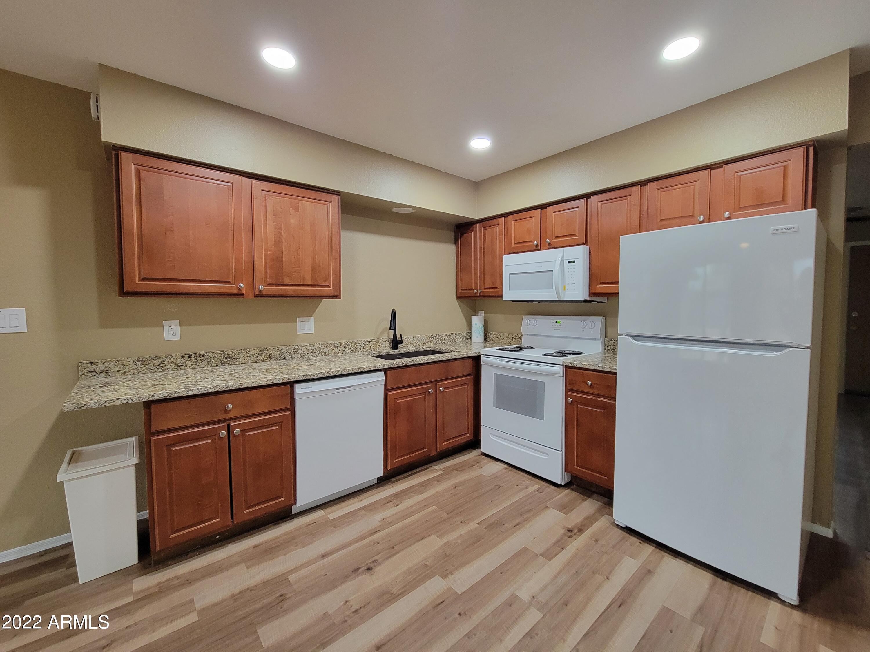 2042 West Decatur Street Mesa, AZ 85201 - Photo 8 of 38 a kitchen with a refrigerator sink and cabinets