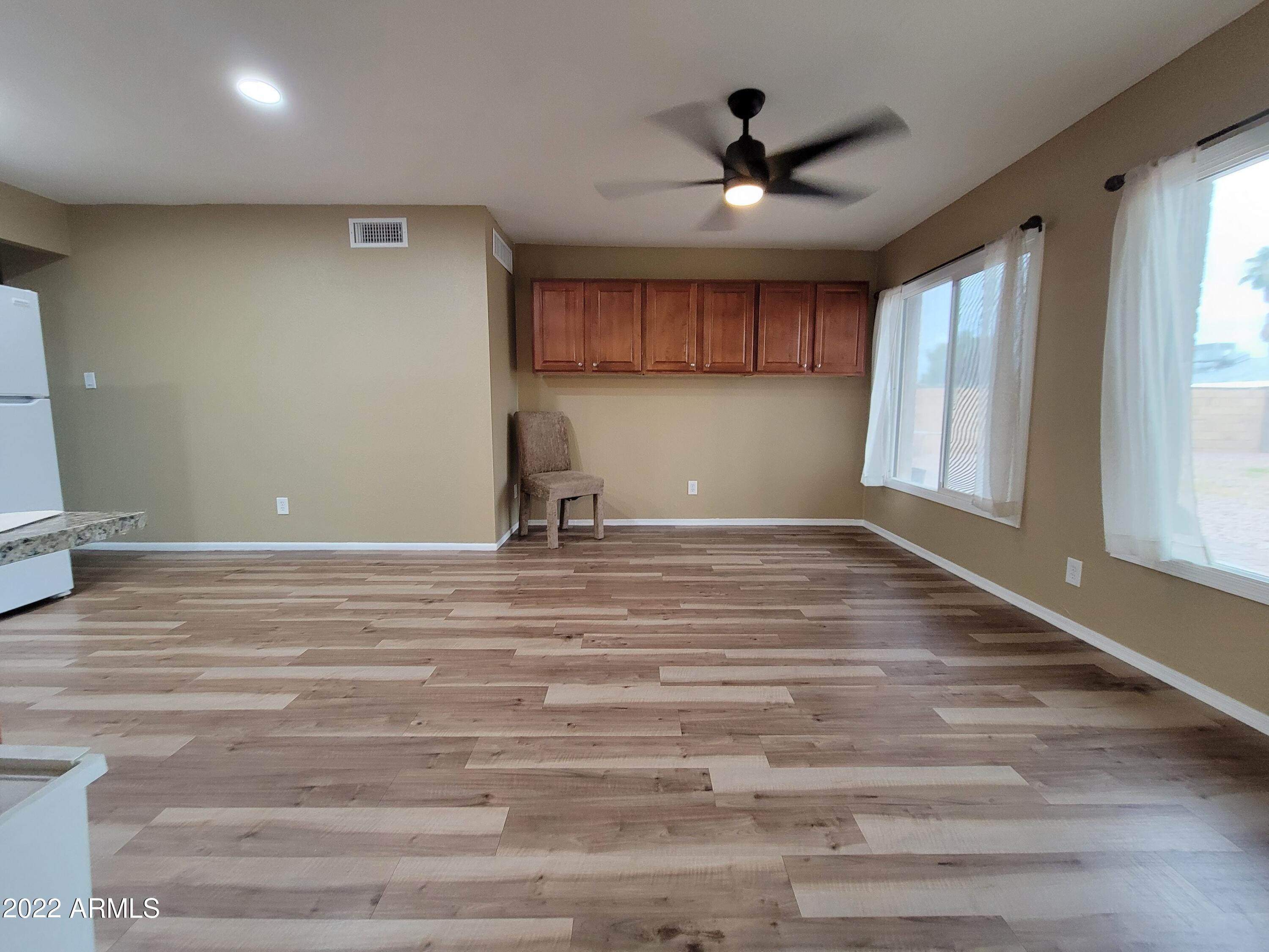 2042 West Decatur Street Mesa, AZ 85201 - Photo 9 of 38 a view of a livingroom with a ceiling fan and window