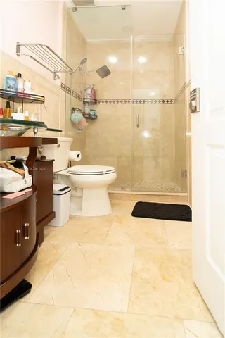 a bathroom with a toilet a sink and shower