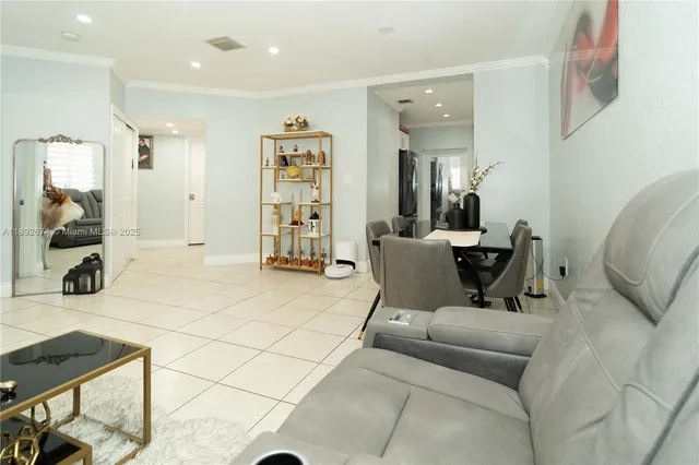 a living room with furniture and a mirror