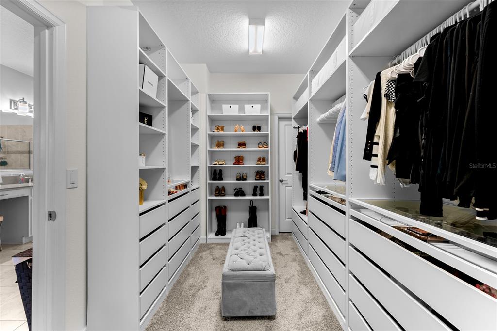 2926 Wordsmith Road Kissimmee, FL 34746 - Photo 30 of 42 a view of walk in closet with clothes and shoes