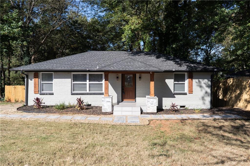 2793 Gresham Rd S East Atlanta, GA 30316 - Photo 1 of 48 a front view of a house with a yard outdoor seating and covered with trees