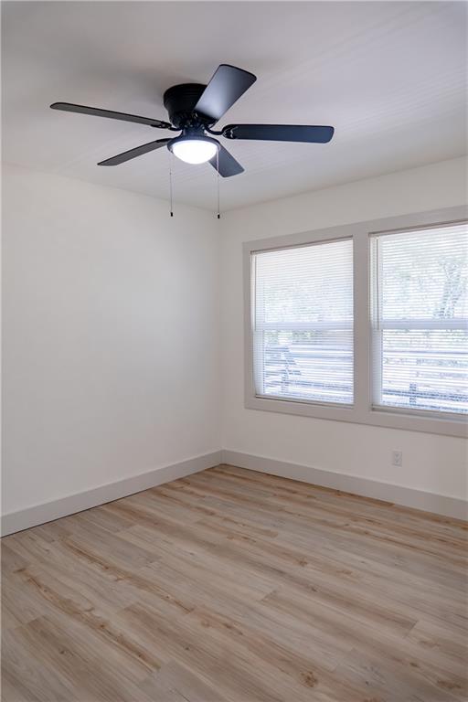2793 Gresham Rd S East Atlanta, GA 30316 - Photo 32 of 48 an empty room with wooden floor fan and windows