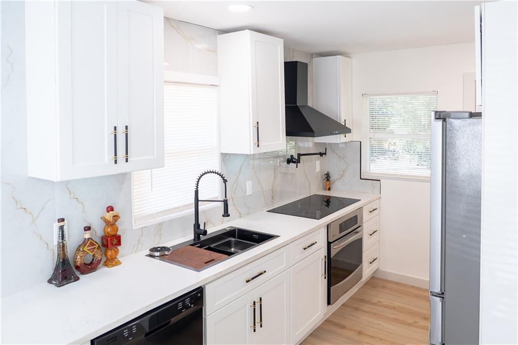2793 Gresham Rd S East Atlanta, GA 30316 - Photo 37 of 48 a kitchen with a sink stove and cabinets
