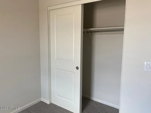 a view of a house with a wooden fence
