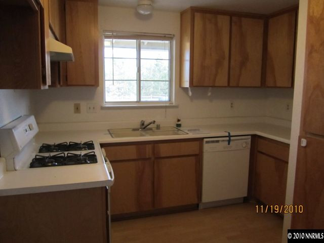 111 Empire Road Dayton, NV 89403 - Photo 3 of 13 a kitchen with sink a stove and cabinets