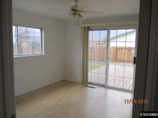 111 Empire Road Dayton, NV 89403 - Photo 7 of 13 an empty room with windows and chandelier fan