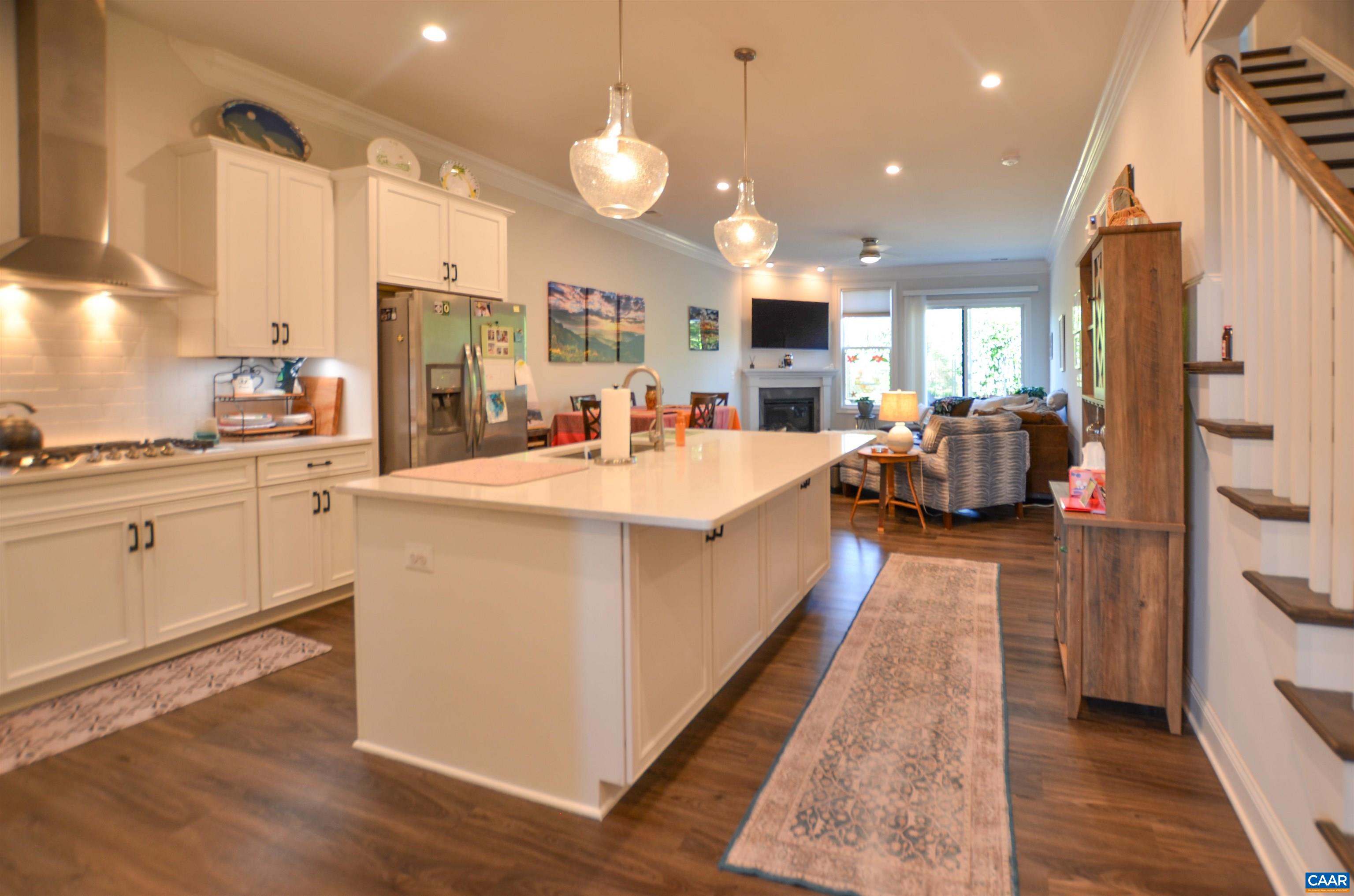 327 Claibourne Road Crozet, VA 22932 - Photo 13 of 36 a large kitchen with stainless steel appliances kitchen island a large counter top a sink a stove and a refrigerator