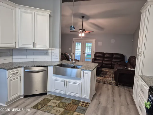 a kitchen with a stove a sink and a refrigerator