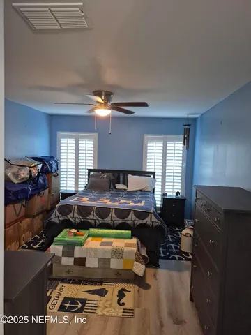 a bedroom with furniture and a window