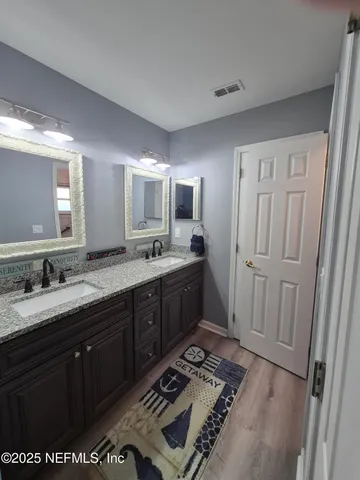 a spacious bathroom with a sink a mirror and a shower
