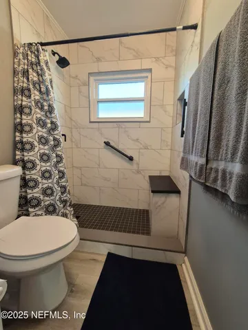 a bathroom with a toilet and a shower
