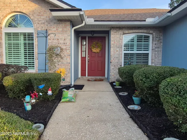 a view of a house that has a flower plants