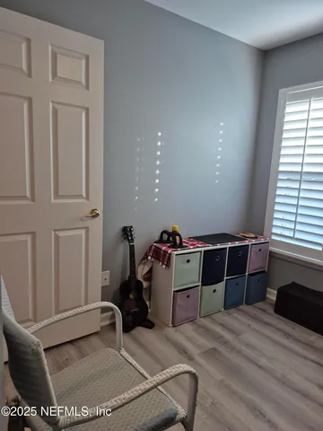 a room with a chair and potted plant