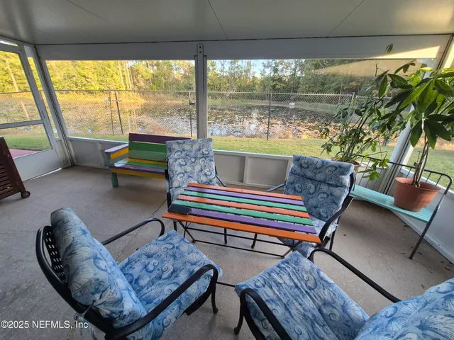 a living room with furniture and a floor to ceiling window
