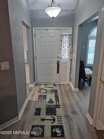 a view of a hardwood and front door