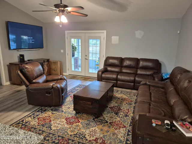 a living room with furniture and a flat screen tv