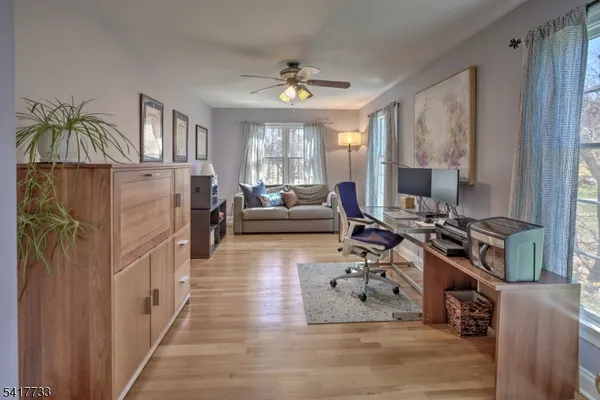 a living room with furniture a chandelier and a flat screen tv