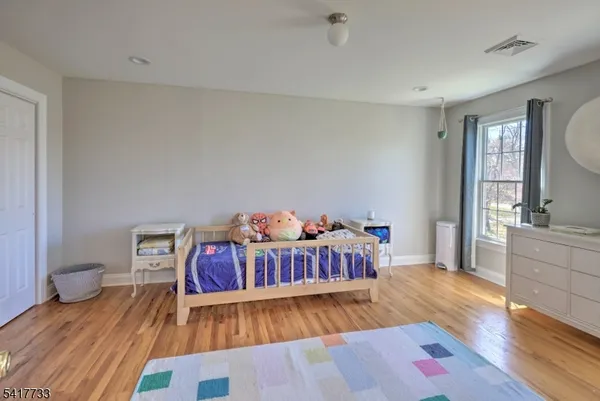 a bedroom with furniture and a wooden floor