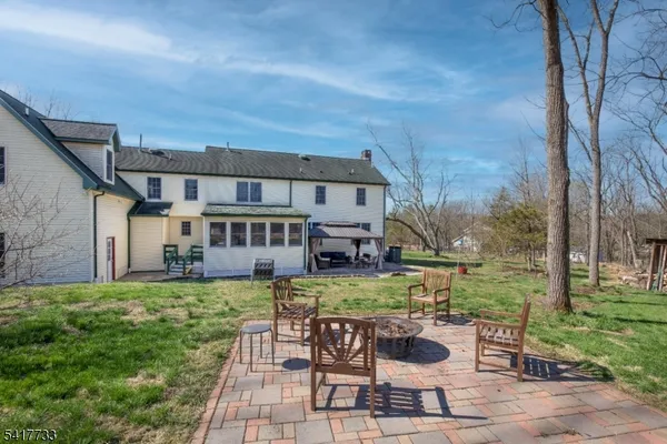 a view of a house with backyard sitting area and garden