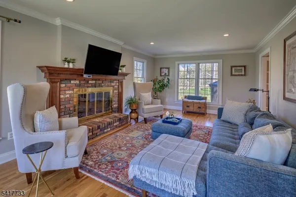 a living room with fireplace furniture and a flat screen tv