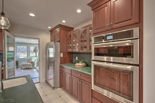 a kitchen with granite countertop stainless steel appliances and wooden cabinets