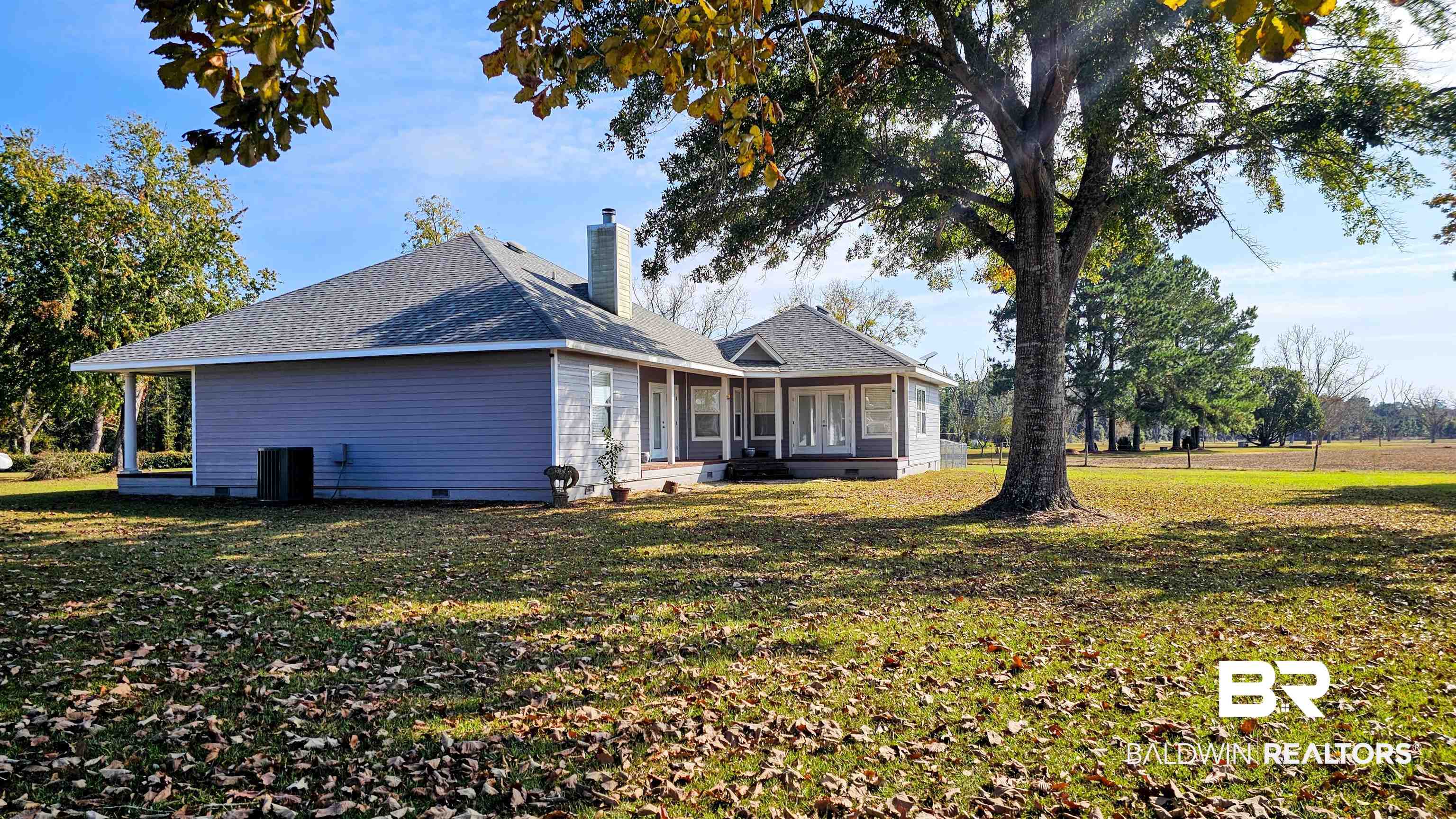 9275 Crawford Road Elberta, AL 36530 - Photo 6 of 28 Rear view of house with a yard, a chimney, roof with shingles, and crawl space