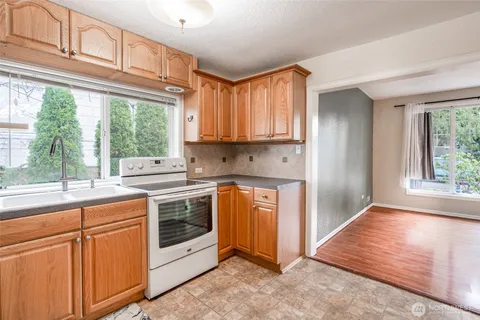 a kitchen with stainless steel appliances granite countertop a stove a sink and a refrigerator