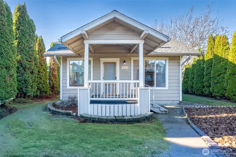 a view of a house with a yard and furniture