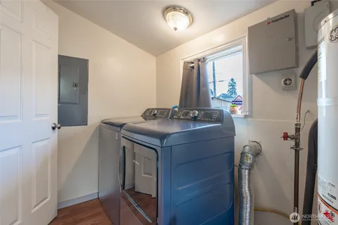 a utility room with cabinets washer and dryer