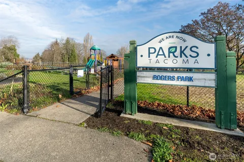a view of a street sign under a tree