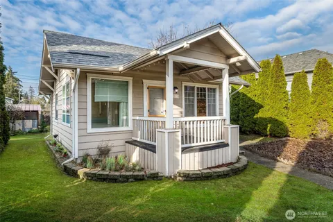 a front view of a house with a yard garden and slide