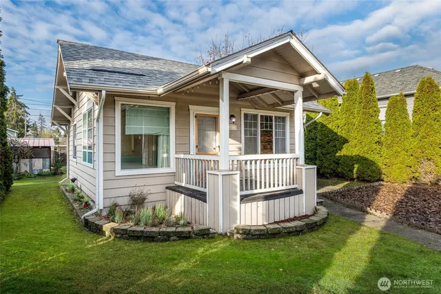 a front view of a house with a yard garden and slide