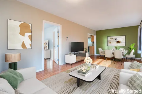 a living room with furniture a rug and a flat screen tv