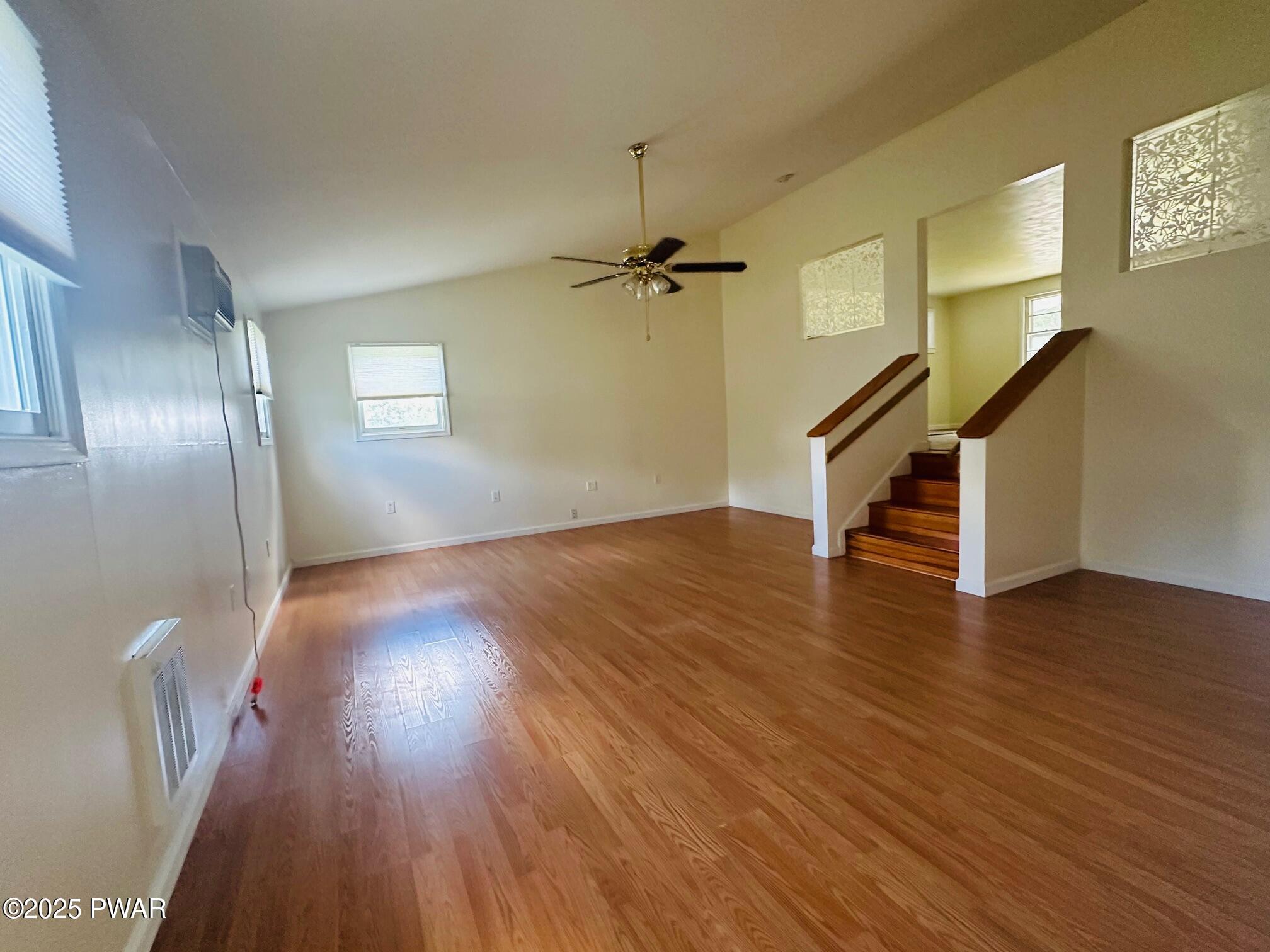 191 Hemlock Grove Road Greentown, PA 18426 - Photo 11 of 31 a view of an empty room with wooden floor and a ceiling fan