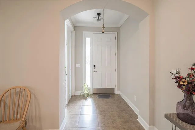a room with fridge and a book shelf