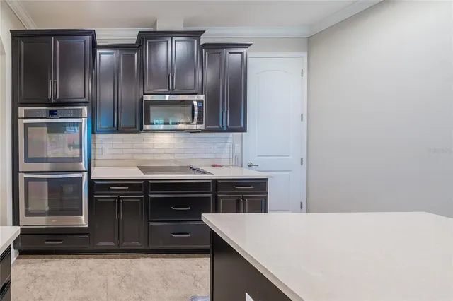 a living room with furniture ceiling fan and a window