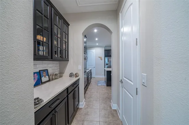 a living room with furniture a chandelier and a flat screen tv