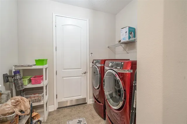 a view of workspace and bedroom with furniture and book shelf